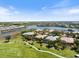 Stunning aerial view of a community with golf course, waterfront homes, and lush landscaping on a clear day at 72 Grande Fairway, Englewood, FL 34223