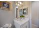 Bright bathroom featuring a modern vanity, framed mirror, and clean design offering a refreshing and stylish space at 72 Grande Fairway, Englewood, FL 34223