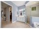 Bathroom featuring a glass shower, tub, and double sinks with walk in closet view at 72 Grande Fairway, Englewood, FL 34223