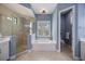 Bathroom featuring a soaking tub, glass shower, and private toilet room at 72 Grande Fairway, Englewood, FL 34223