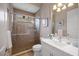 Stylish bathroom featuring a glass-enclosed shower, white vanity, and modern fixtures for a spa-like experience at 72 Grande Fairway, Englewood, FL 34223