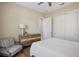 Bedroom with hard surface floors, ceiling fan, a chair, closet, and a dresser at 72 Grande Fairway, Englewood, FL 34223
