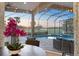 Cozy breakfast nook provides views of the pool, screened lanai, and the lush green golf course at 72 Grande Fairway, Englewood, FL 34223