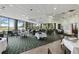 A well-lit dining room with large windows and neatly arranged tables and chairs at 72 Grande Fairway, Englewood, FL 34223
