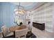 Formal dining room features designer lighting, accent wall, and a bar with wine storage at 72 Grande Fairway, Englewood, FL 34223