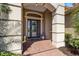 Elegant front door with a transom window, decorative pillars, and a charming 'hello' welcome mat at 72 Grande Fairway, Englewood, FL 34223
