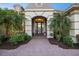 Inviting front entrance with a brick walkway, elegant doorway, and beautifully landscaped surroundings at 72 Grande Fairway, Englewood, FL 34223