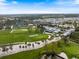 Aerial view of an immaculately maintained golf course with manicured greens, mature trees, and well-placed sand traps at 72 Grande Fairway, Englewood, FL 34223