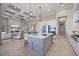 Gourmet kitchen features a large island with seating, modern lighting, and stainless steel appliances at 72 Grande Fairway, Englewood, FL 34223