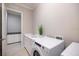 Laundry room with a washer, countertop, white cabinets and stainless steel sink at 72 Grande Fairway, Englewood, FL 34223