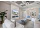 Living room with modern fireplace, tiled accent wall, and beautiful tray ceiling with fan at 72 Grande Fairway, Englewood, FL 34223