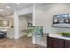 Hallway space with seating and a TV displaying property information at 72 Grande Fairway, Englewood, FL 34223