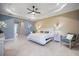Spacious main bedroom with tray ceilings, ensuite bathroom and generous natural light at 72 Grande Fairway, Englewood, FL 34223
