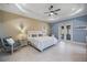 Bright main bedroom with tray ceilings and French doors leading to the lanai at 72 Grande Fairway, Englewood, FL 34223