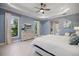 Serene main bedroom with large windows, dresser, and ensuite bathroom entrance at 72 Grande Fairway, Englewood, FL 34223