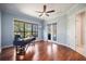 Office with large window, French doors to lanai/pool, hardwood flooring, and a ceiling fan at 72 Grande Fairway, Englewood, FL 34223
