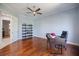 Spacious office with hardwood floors, ceiling fan, a large desk, and a decorative shelf at 72 Grande Fairway, Englewood, FL 34223