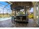 Resort style covered outdoor bar overlooking a pool and golf course at 72 Grande Fairway, Englewood, FL 34223