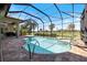Screened-in pool and spa offer a refreshing escape with a view of the lush golf course at 72 Grande Fairway, Englewood, FL 34223