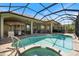 Stunning pool and spa in a screened lanai, complemented by a built-in tiki bar at 72 Grande Fairway, Englewood, FL 34223