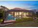 Screened-in pool and hot tub area with an outdoor kitchen and spacious patio, perfect for relaxation and entertainment at 72 Grande Fairway, Englewood, FL 34223