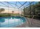 Screened pool and spa with golf course views, featuring convenient access handrails at 72 Grande Fairway, Englewood, FL 34223