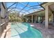 A luxurious pool, hot tub, and a covered lanai complete with a tiki bar at 72 Grande Fairway, Englewood, FL 34223