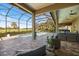 Outdoor living space with pool, spa, screened lanai, and golf course view in the distance at 72 Grande Fairway, Englewood, FL 34223