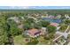 Beautiful aerial view of a landscaped home with solar panels and a screened lanai in a lush community at 7602 Partridge Street Cir, Bradenton, FL 34202