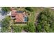 Aerial view of home showcasing solar panels, tile roof, screened-in pool, and landscaping at 7602 Partridge Street Cir, Bradenton, FL 34202