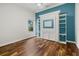 Stylish bedroom features a built-in Murphy bed, shelving, and rich hardwood floors at 7602 Partridge Street Cir, Bradenton, FL 34202