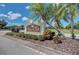 Elegant 'River Club' community sign with palm trees and landscaped surroundings at 7602 Partridge Street Cir, Bradenton, FL 34202