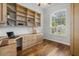Home office with custom wood built-ins, shelving, and a large window with natural light at 7602 Partridge Street Cir, Bradenton, FL 34202