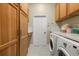 This laundry room features a washer and dryer and ample storage space at 7602 Partridge Street Cir, Bradenton, FL 34202