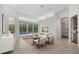 Open living room with sleek furnishings, tile floors, and large sliding doors leading to the pool area at 7602 Partridge Street Cir, Bradenton, FL 34202
