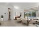 Bright living room with stylish furniture, wood flooring, and sliding doors to the outdoor pool area at 7602 Partridge Street Cir, Bradenton, FL 34202