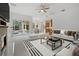 Spacious living room showcasing a fireplace, comfortable seating, and sliding doors to a screened lanai with a pool at 7602 Partridge Street Cir, Bradenton, FL 34202