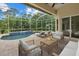 Relaxing screened patio with a beautiful pool, comfortable lounge chairs, and a ceiling fan at 7602 Partridge Street Cir, Bradenton, FL 34202