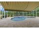 A refreshing screened-in pool with a travertine deck and automatic awning at 7602 Partridge Street Cir, Bradenton, FL 34202