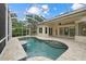 A refreshing screened-in pool with travertine deck and covered patio at 7602 Partridge Street Cir, Bradenton, FL 34202