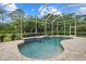 Relaxing pool area surrounded by lush landscaping and a screened enclosure at 7602 Partridge Street Cir, Bradenton, FL 34202