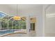 View of the pool from inside the kitchen and casual dining area at 7602 Partridge Street Cir, Bradenton, FL 34202