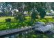 Beautiful backyard featuring a boat dock, waterfront access, and mature trees at 8467 Imperial Cir, Palmetto, FL 34221