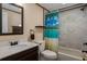 This is a full bathroom with a vanity, toilet, bathtub, and shower with a tropical shower curtain at 8467 Imperial Cir, Palmetto, FL 34221