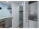 Bathroom including gray cabinet, white countertop, shower with glass doors, and washer and dryer at 8467 Imperial Cir, Palmetto, FL 34221