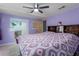 This is a bedroom with an ensuite bathroom area, decorated with lavender colored walls at 8467 Imperial Cir, Palmetto, FL 34221