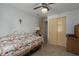 Bedroom with twin bed, tan floors and white walls at 8467 Imperial Cir, Palmetto, FL 34221