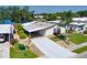 Well-kept single-story home with carport, landscaping, and lake view in a sunny setting at 8467 Imperial Cir, Palmetto, FL 34221