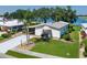 Attractive single-story home featuring a well-maintained lawn and a covered carport at 8467 Imperial Cir, Palmetto, FL 34221