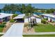 Well-maintained single-story home featuring a covered carport and a partial lake view at 8467 Imperial Cir, Palmetto, FL 34221